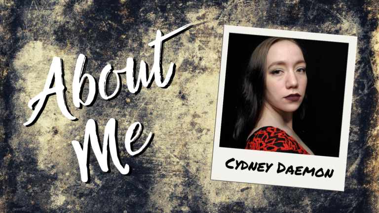 A dark gray and cream stone background with About Me scrawled in a messy cursive font on the left with a polaroid picture of the author Cydney Daemon on the right. Cydney Daemon appears to be a woman with tawny beige skin, dark hair, hazel eyes, dark red lipstick, and a black and red shirt.
